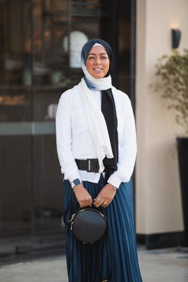 Hijabi Model wearing EMMA scarf Ebony North, in the Ombre colors of black and offwhite. in Zara pleated skirt