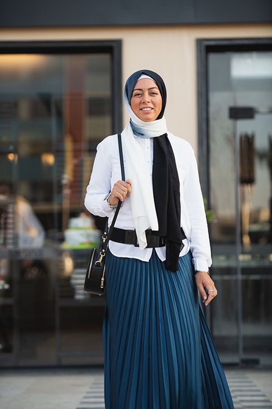 Hijabi Model wearing EMMA scarf Ebony North, in the Ombre colors of black and offwhite. in Zara pleated skirt