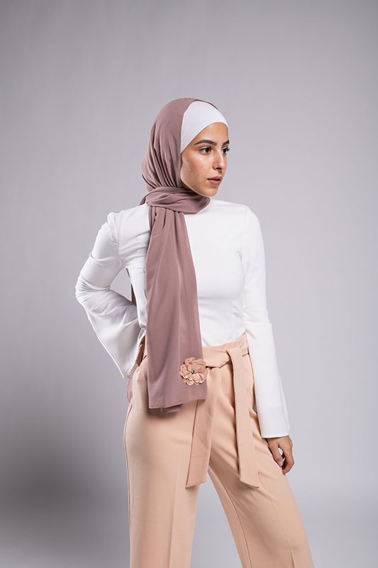 light skinned Hijabi girl in EMMA Scarf Dazzle In Mauve with an embroidered sequin flower and diamond on it on a chiffon mauve hijab
