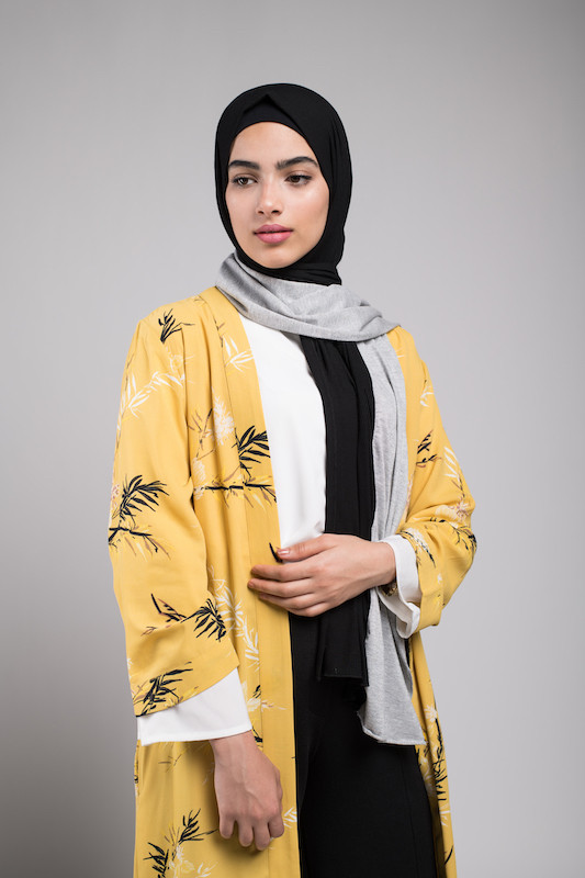 Hijabi Model in EMMA Scarf Midnight sugar looking to th side ith her palm on her stomach