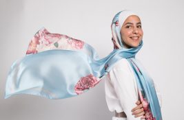 Hijabi Model in EMMA Scarf Aqua Fleuri with her hijab flowing behind her