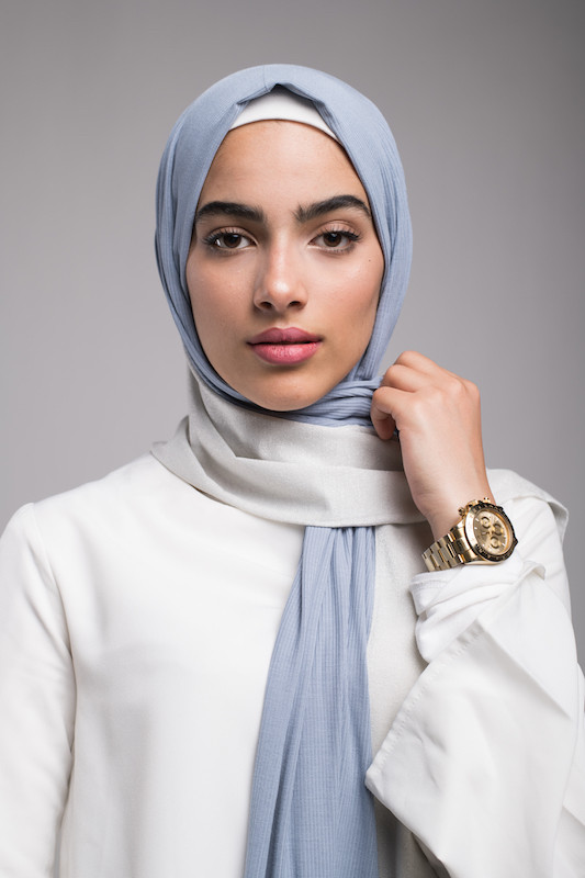 close up of hijabi model in EMMA Scarf Blue sugar , a premium jersey cotton scarf in the color blue with a subtle silver shine