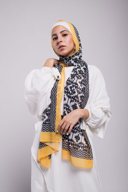Hijabi model in EMMA SCraf aztec sunshine with yellow border, hand on her shoulder