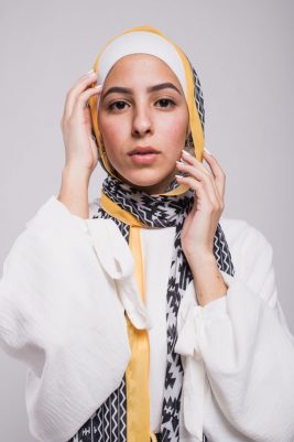 Hijabi model in EMMA Scarf with her hand on her face