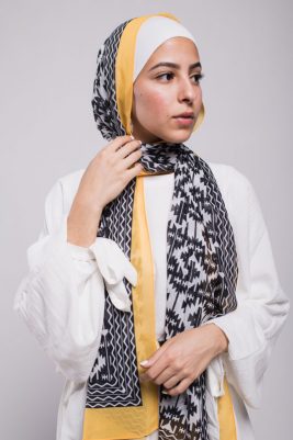 Close up of hijabi model in EMMA Scarf Aztec sunshine looking to her side