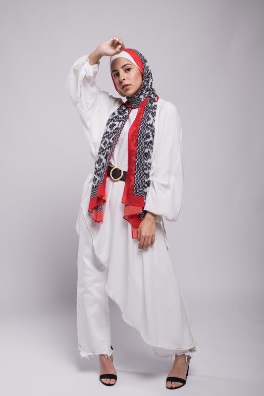 Hijabi model In EMMA scarf Aztec Rouge with her hand on her forehead