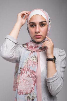 close up of hijabi in EMMA Scarf Honey Blooms Chiffon with her hand on her face and head
