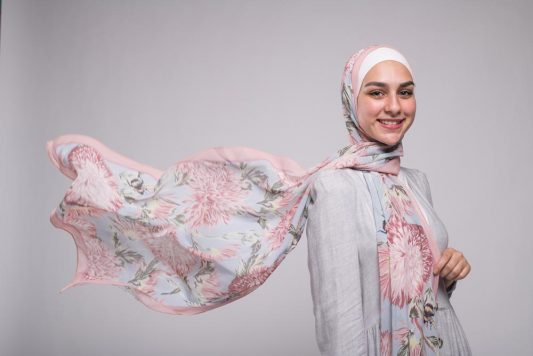 Hijabi Model in EMMA scarf Honey Blooms Chiffonsmiling at camera with her hijab flying