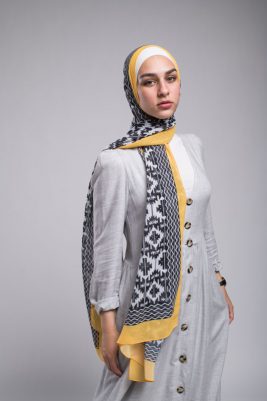 Hijabi model in EMMA Scarf Aztec sunshine staring at te camera from the side