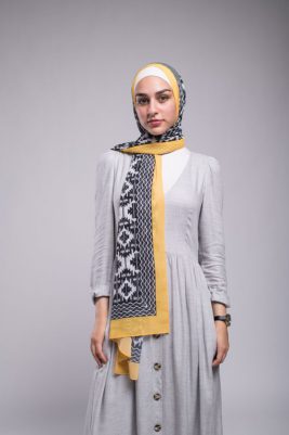 Hijabi model in EMMA Scarf Aztec sunshine with her hand on her waist