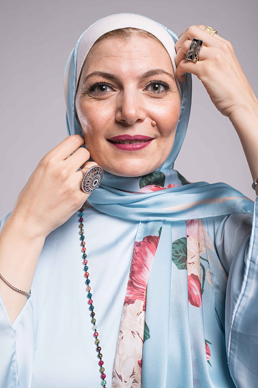 A close up f a hijabi woman with green eyes in EMMA Aqua Fleuri