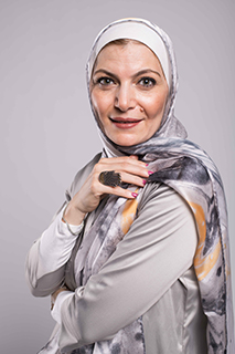 A close up f a hijabi woman in EMMA scarf Galaxy Luna staring at camera