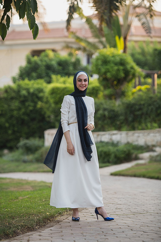 full body of a hijabi model in EMMA Scarf Navy Shimmer and a white dress for her STYLE EDIT with EMMA