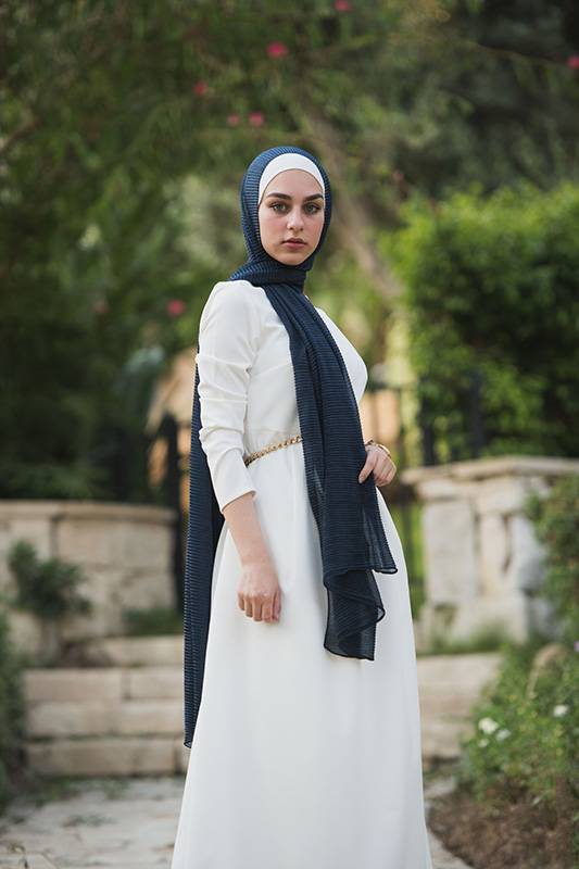 full body of a hijabi model in EMMA Scarf Navy Shimmer and a white dress for her STYLE EDIT with EMMA