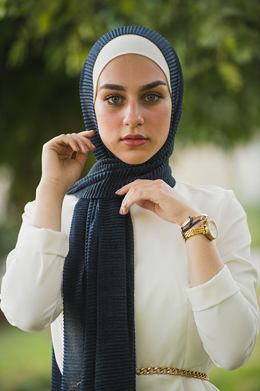 close up of hijabi model in EMMA Scarf Navy Shimmer staring at camera
