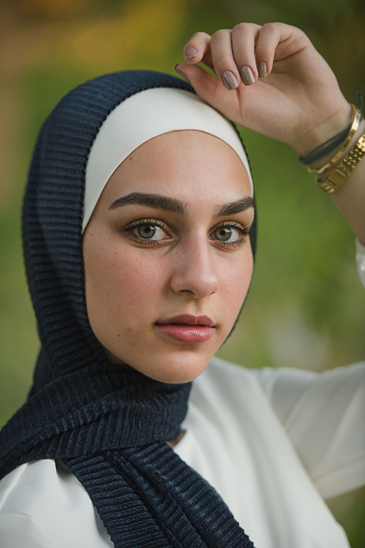 Close up of hijani model in EMMA scarf Navy Shimmer staring at camera
