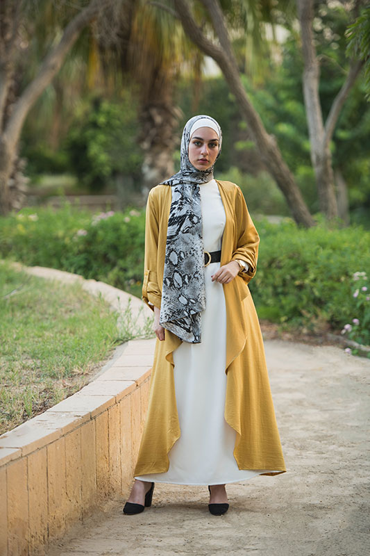 full body shot of hijabi model in EMMA Scarf Black Python,a maxi white dress, heels and mustard kimono