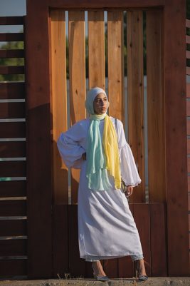 full body of a hijabi model in her EMMA Scarf Kiwi Zest looking at a distance m with her hand on her waist