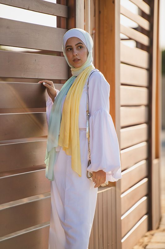 A hijabi model in EMMA Scarf Kiwi Zest in an ombre of yellow and light green mint color