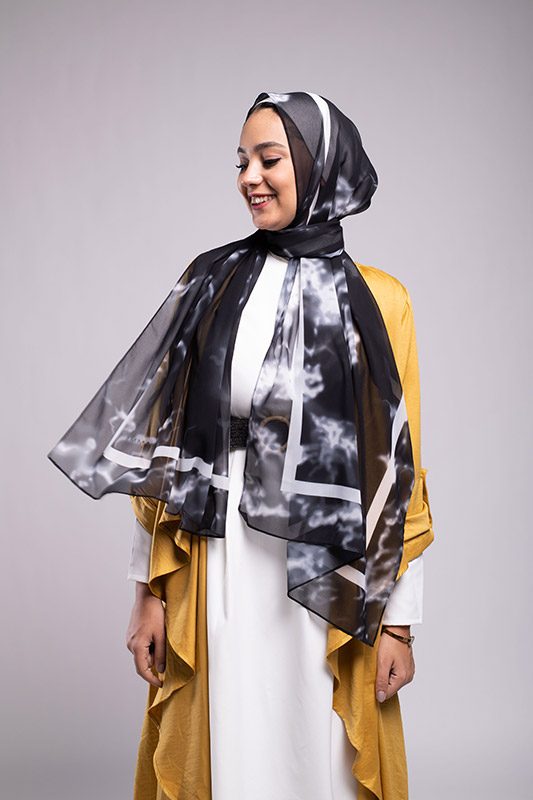 smiling Hijabi Model wearing EMMA Scarf Black Marble with the hijab flowing