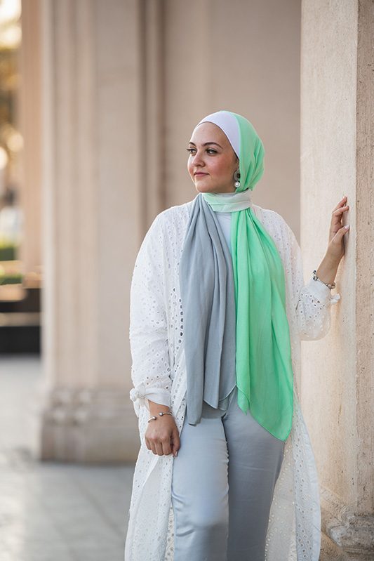 White Hijabi wearing EMMA Scarf Apple crunch and a white lace kimono