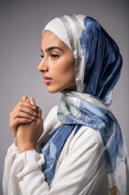 Hijabi Model in EMMA Satin Hijab Pareisienne Azure, with gold geometric lines,Roses in hues of blue and grey liines