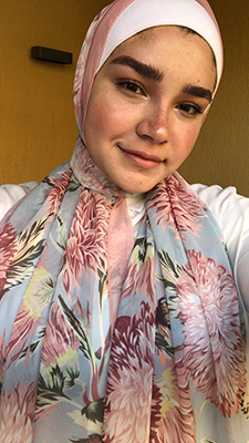 EMMA Customer taking a selfie in her EMMA hijab Honey Blooms Chiffon