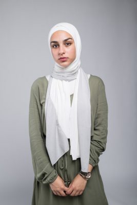 Close up of white hijabi model in EMMA Scarf Silver Sugar staring at camera