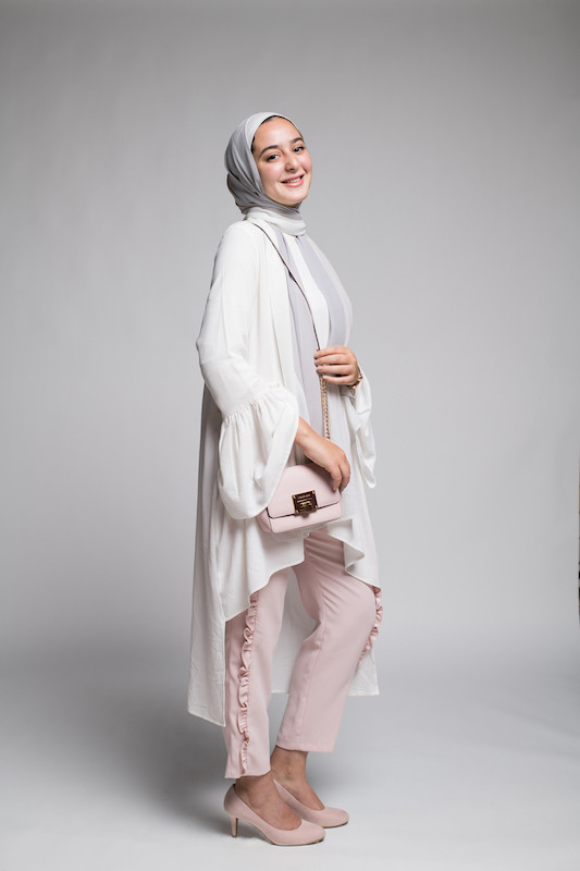 hijabi model in EMMA Scarf Vanilla Ice , a long white frill tio and oink oants with frills along the side