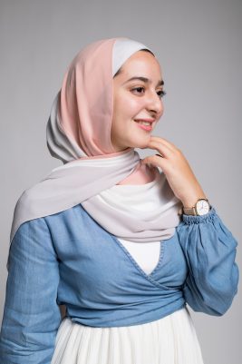 Hijabi Mode in EMMA Scarf Peach n Vanilla lookng to the side in a low cut shirt