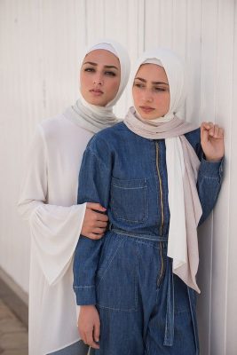 two hijabi models in EMMA Scarfs grey sugar and pink sugar , on staring at camera with her hand on the others elbow