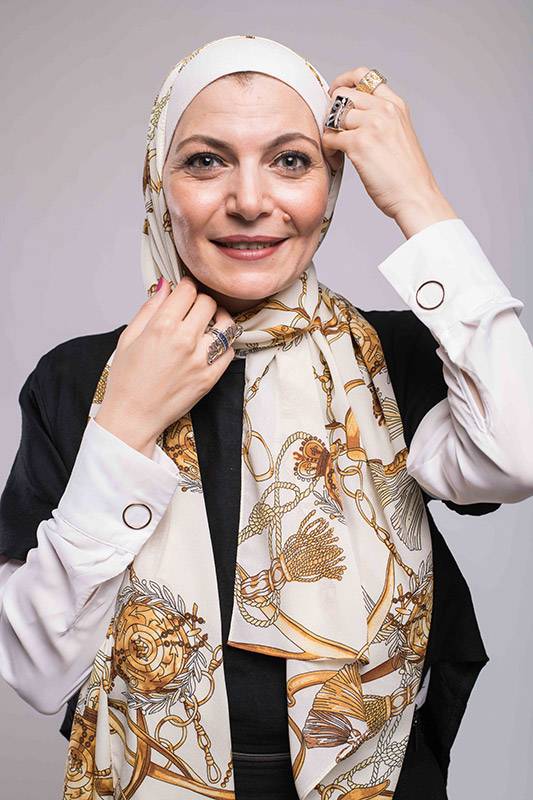 A close up f a hijabi woman in EMMA scarf Chains D'ior