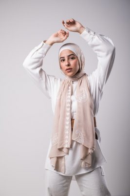 hijabi model in EMMA Scarf Love Me nude staring at camera with her hand in the air
